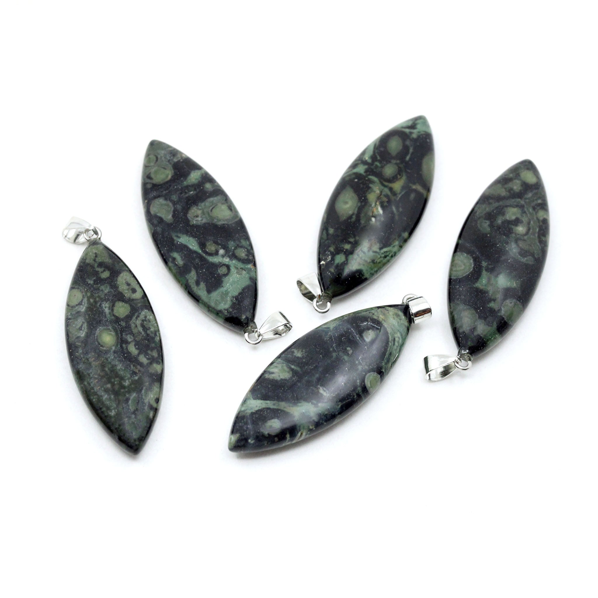 Five surfboard shaped pendants made from Kambaba Jasper with on a white background. Kambaba Jasper is dark green and black with orb-like formations that resemble fossilized algae or crocodile eyes.