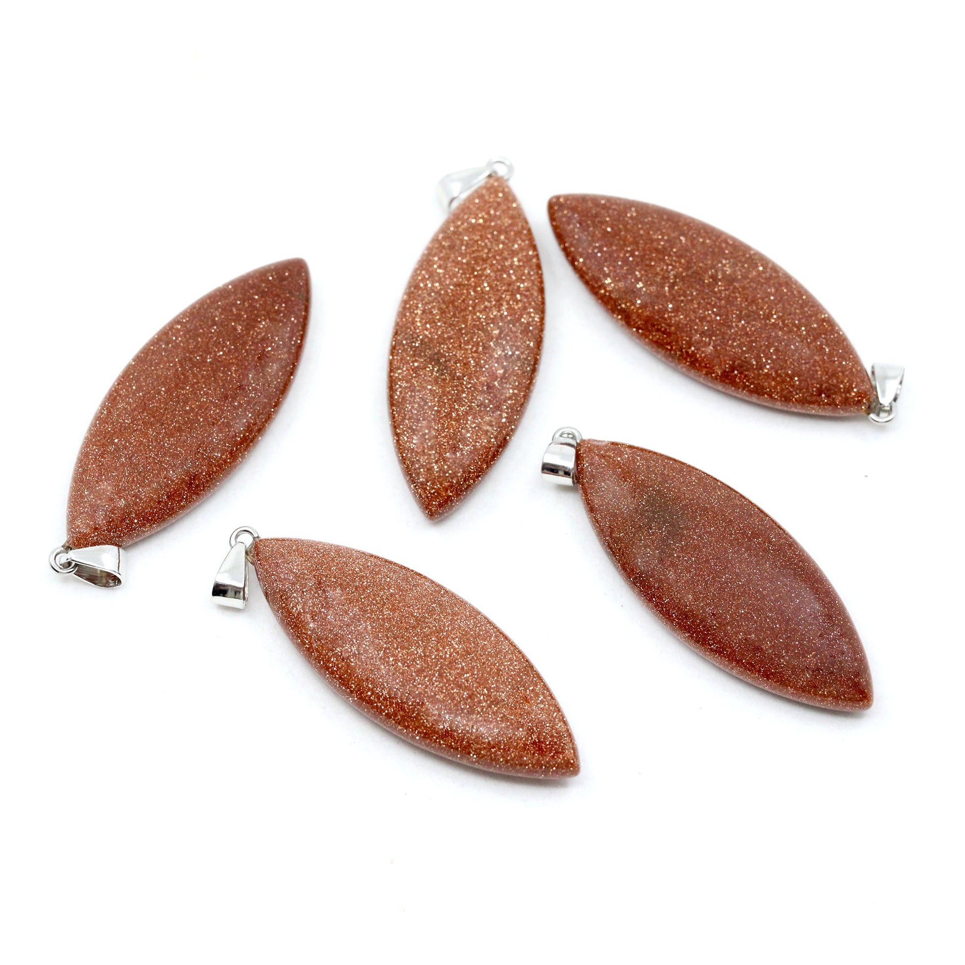 Five surfboard shaped pendants made from Red Goldenstone on a white background.